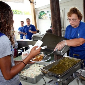 Volunteers serve lunch at the Freshwater Farms Food Booth